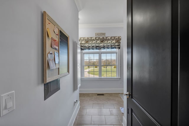 doorway with light tile patterned flooring and crown molding