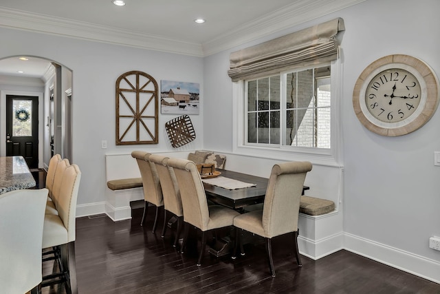 dining area featuring dark hardwood / wood-style floors and crown molding