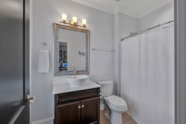 bathroom featuring toilet, ornamental molding, vanity, and hardwood / wood-style flooring