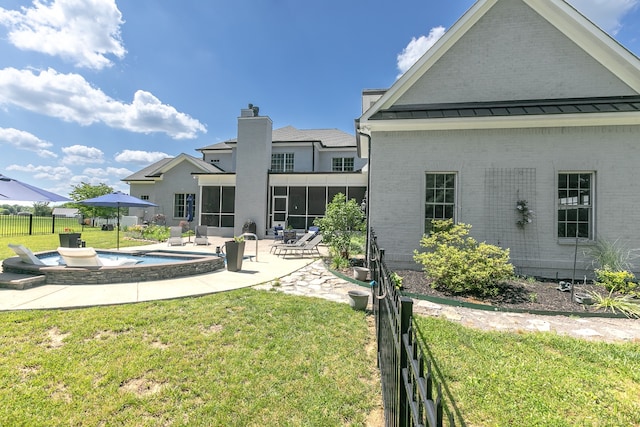 rear view of house with a patio, a fenced in pool, and a lawn