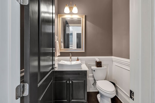 bathroom featuring vanity, toilet, and hardwood / wood-style floors