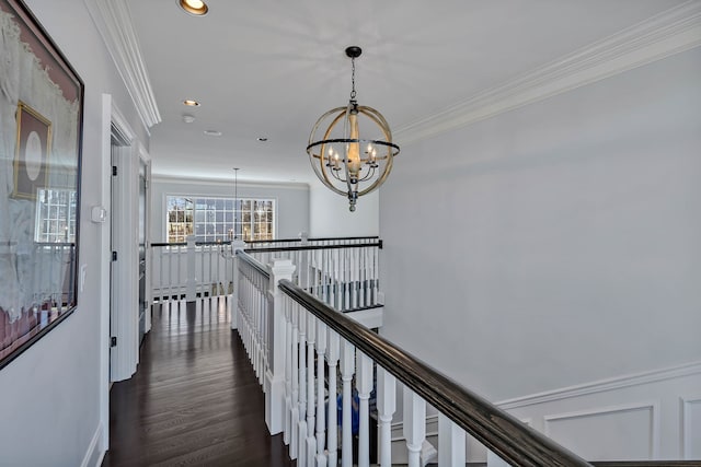 corridor featuring crown molding, dark wood-type flooring, and a chandelier