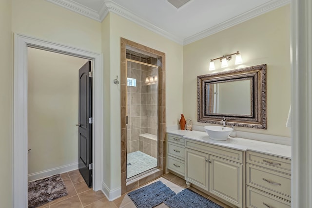 bathroom with a shower with shower door, vanity, crown molding, and tile patterned flooring