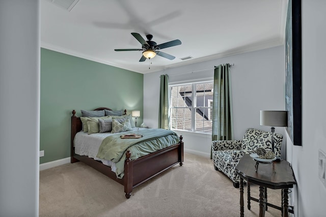 carpeted bedroom with ceiling fan and ornamental molding