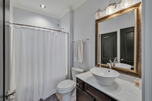 bathroom with ornamental molding, vanity, and toilet