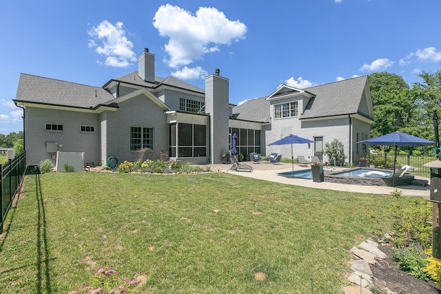 back of house featuring a swimming pool with hot tub, a patio, and a yard