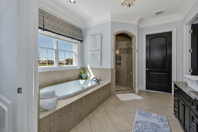 bathroom featuring ornamental molding, vanity, plus walk in shower, and tile patterned flooring