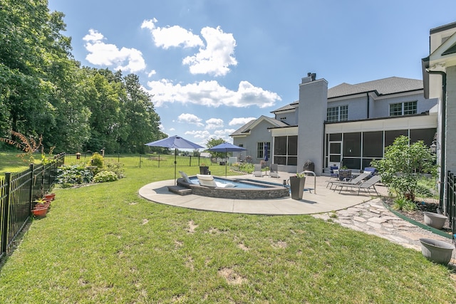 view of yard featuring a sunroom, a patio, and a fenced in pool