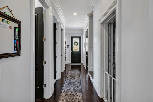 hallway featuring dark hardwood / wood-style floors and crown molding