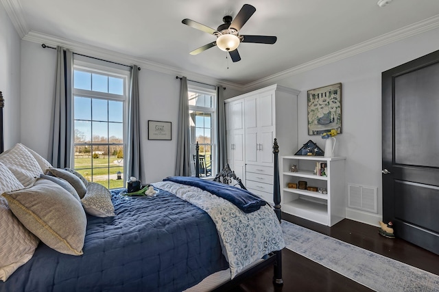 bedroom featuring ceiling fan, crown molding, multiple windows, and dark hardwood / wood-style floors