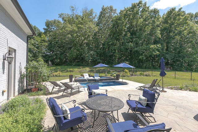 view of pool with a lawn and a patio area