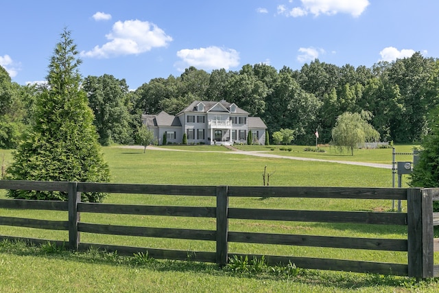 view of gate featuring a rural view and a yard