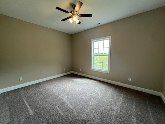 carpeted spare room with ceiling fan