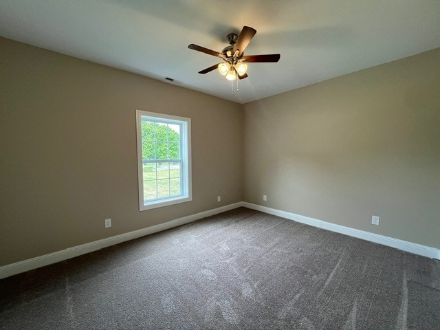 empty room with ceiling fan and carpet floors