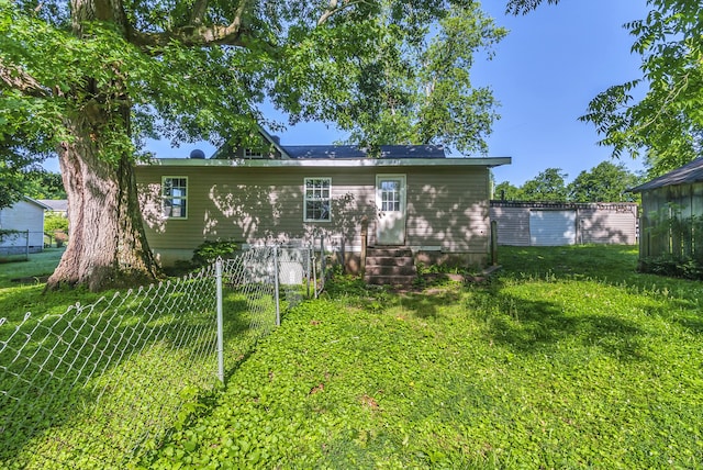 back of property featuring a lawn