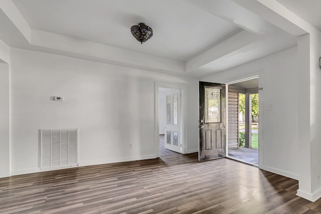 unfurnished room featuring hardwood / wood-style flooring and a raised ceiling