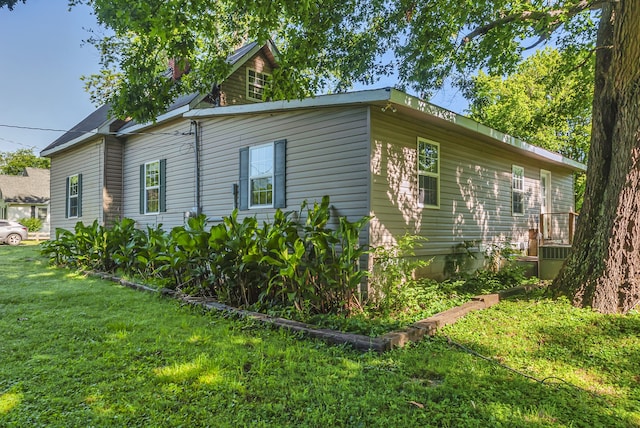 view of property exterior with a lawn