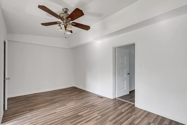 unfurnished room with ceiling fan, vaulted ceiling, and hardwood / wood-style floors