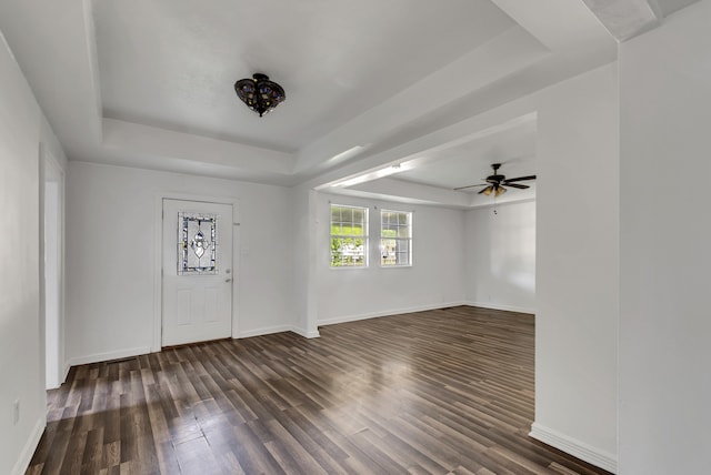 entrance foyer featuring ceiling fan, dark hardwood / wood-style flooring, and a tray ceiling