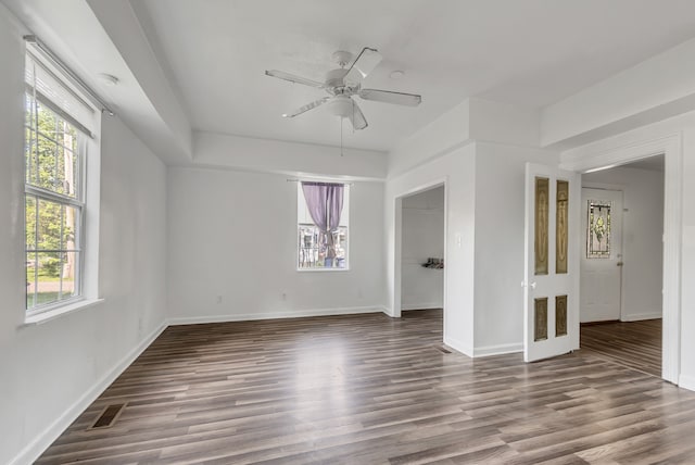 unfurnished room with hardwood / wood-style floors, a healthy amount of sunlight, and ceiling fan