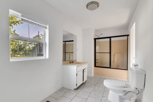 bathroom with vanity, tile patterned flooring, and toilet