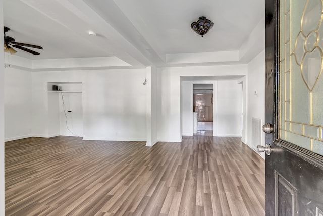 entrance foyer with ceiling fan, hardwood / wood-style flooring, and a tray ceiling