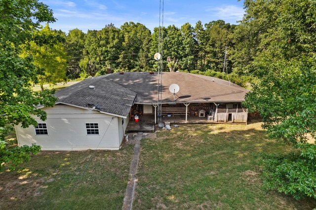 rear view of house featuring a yard