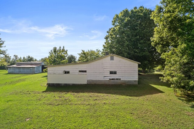 view of side of property with a yard