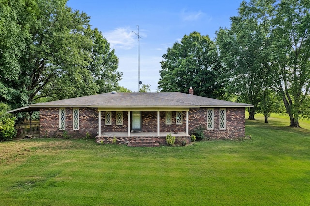 view of front of house featuring brick siding, a chimney, and a front lawn