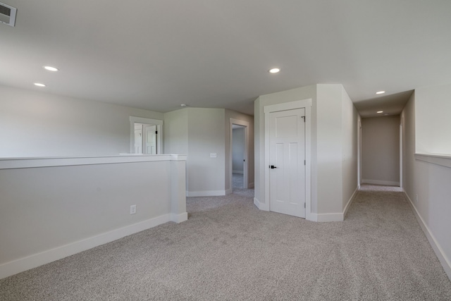 empty room featuring light carpet