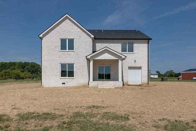 back of house with a garage