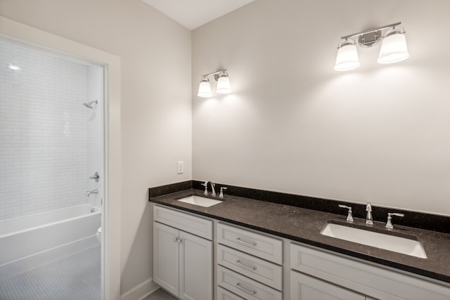 full bathroom featuring toilet, washtub / shower combination, double sink vanity, and tile patterned flooring