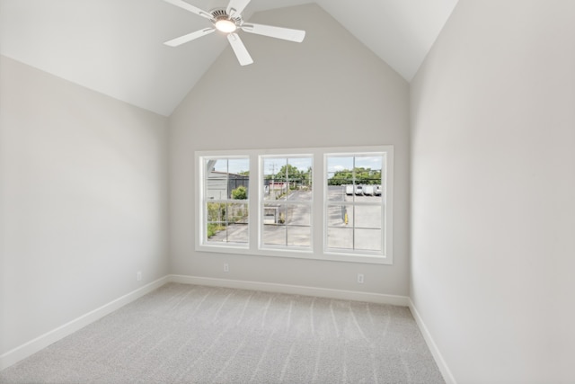 empty room featuring ceiling fan, high vaulted ceiling, and carpet flooring