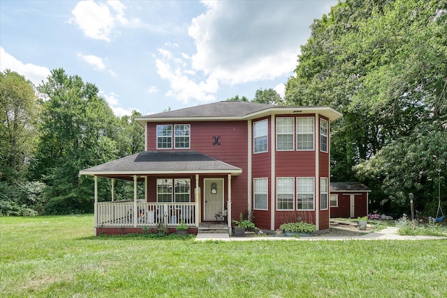 view of front facade featuring an outdoor structure, a front lawn, and covered porch