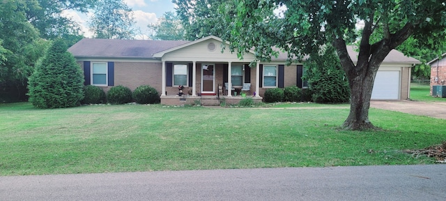 ranch-style home with a porch, a front yard, brick siding, and driveway