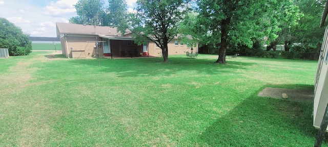 view of yard featuring central air condition unit