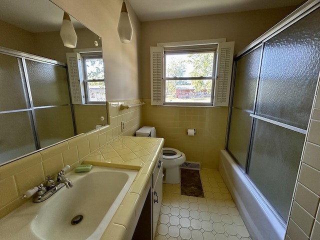 1716 Keller Ave, Pulaski, TN 38478 - full bath with a wealth of natural light, toilet, tile patterned flooring, and tile walls