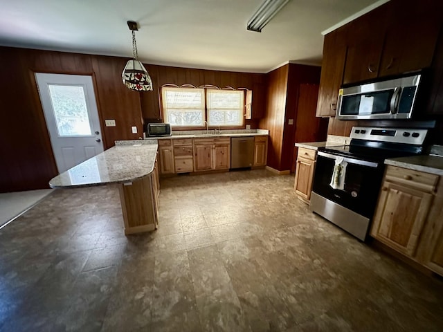 1716 Keller Ave, Pulaski, TN 38478 - kitchen with wooden walls, a sink, decorative light fixtures, and appliances with stainless steel finishes