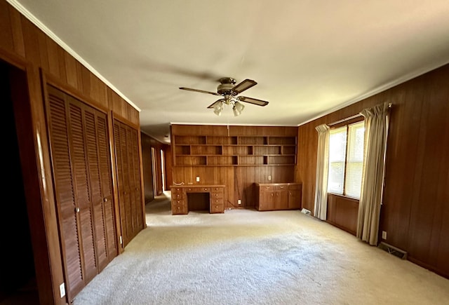 1716 Keller Ave, Pulaski, TN 38478 - interior space featuring visible vents, wood walls, ceiling fan, and light colored carpet