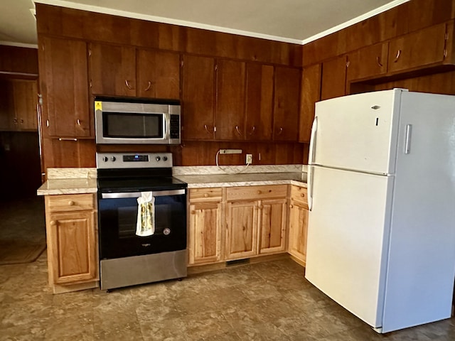 kitchen featuring stainless steel appliances, ornamental molding, and wooden walls