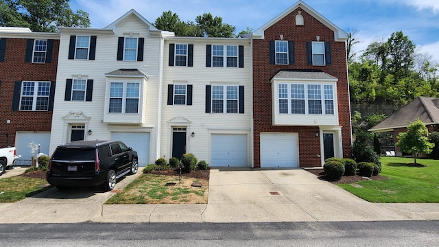 view of property featuring a front lawn and a garage