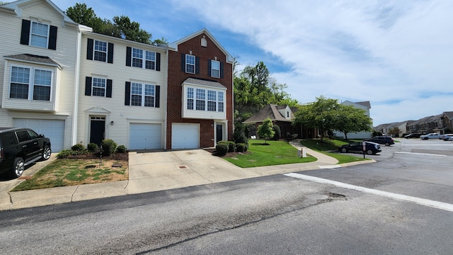 view of property featuring a front yard and a garage