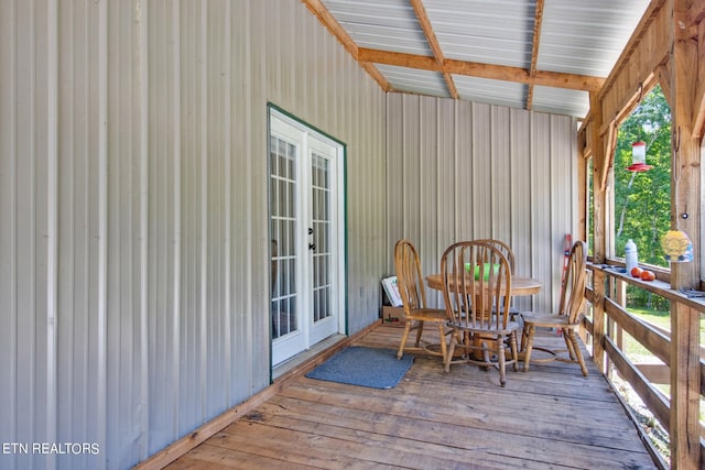 sunroom / solarium featuring beamed ceiling