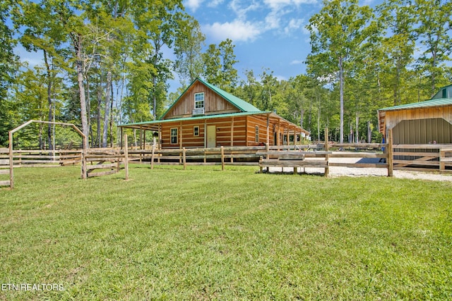 rear view of property with an outdoor structure