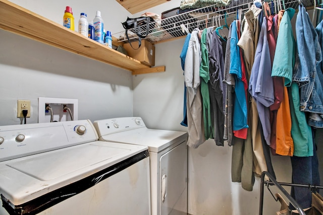 washroom with washing machine and clothes dryer