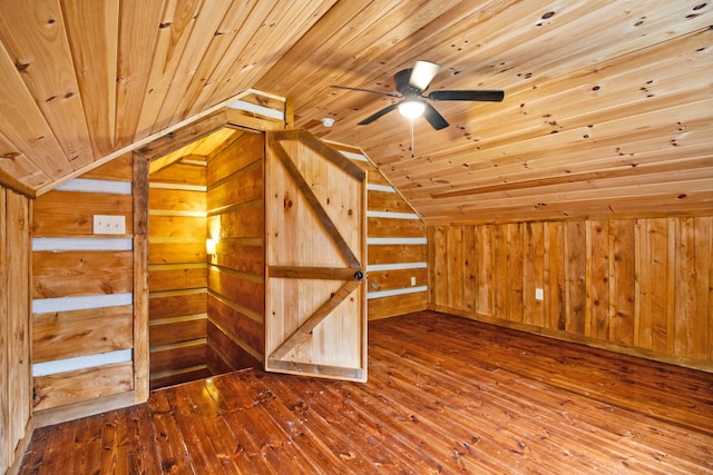 additional living space featuring hardwood / wood-style flooring, lofted ceiling, wooden walls, and wooden ceiling