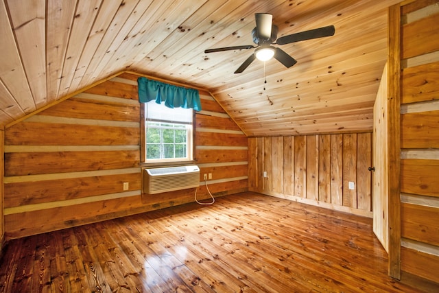 additional living space with wooden walls, vaulted ceiling, hardwood / wood-style flooring, a wall mounted AC, and wood ceiling