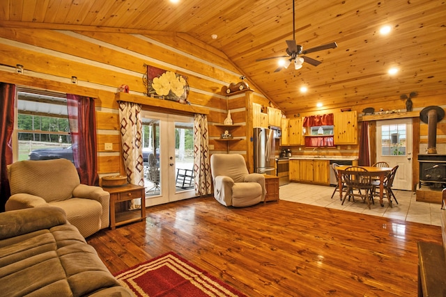 living room featuring a healthy amount of sunlight, wood ceiling, and light hardwood / wood-style flooring