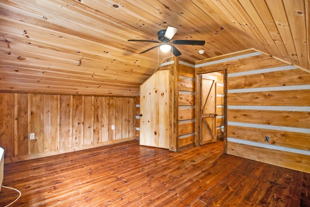 bonus room with wood walls, wooden ceiling, vaulted ceiling, ceiling fan, and wood-type flooring