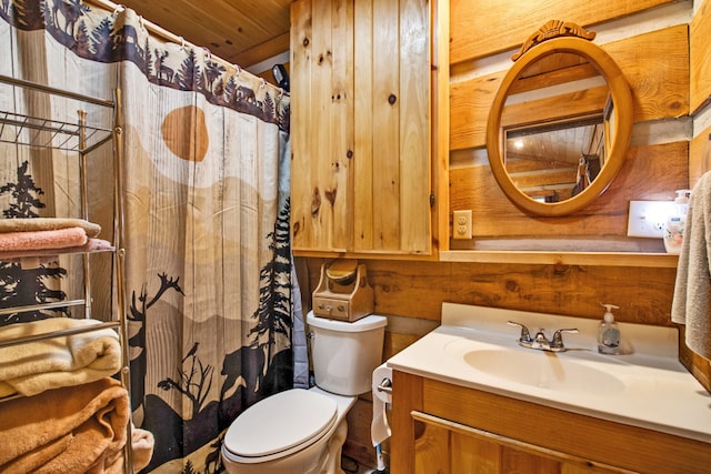 bathroom with vanity, wood walls, toilet, and wooden ceiling